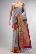 Pure Silk Grey Kanchipuram Saree with Zari Butta on the body and Zari Border.  displayed on a mannequin