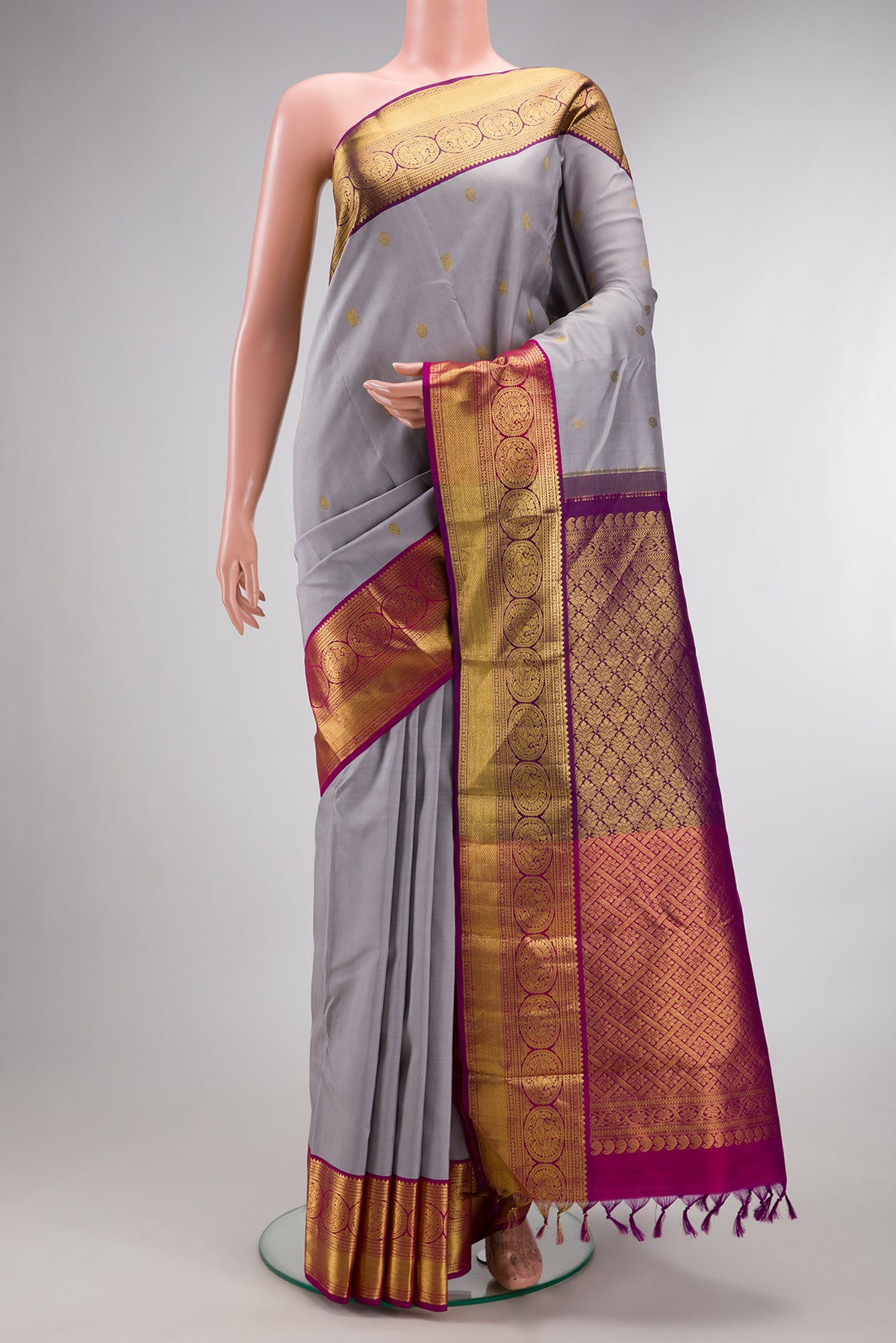 Pure Silk Grey Kanchipuram Saree with Zari Butta on the body and Zari Border.  displayed on a mannequin