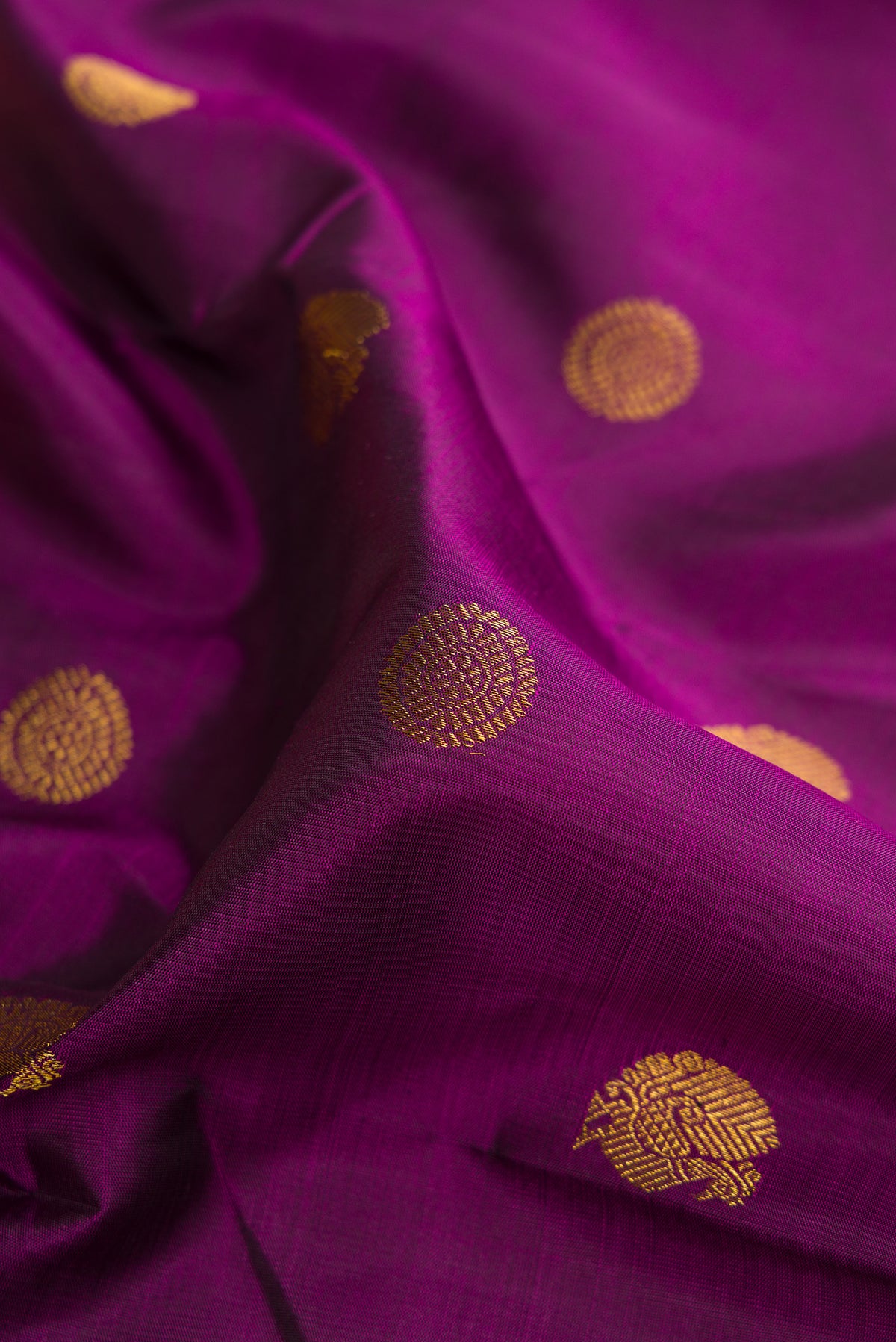 Close up of Pure Silk Purple Kanchipuram Saree with Zari Butta on the body and Zari Border.  displaying folds