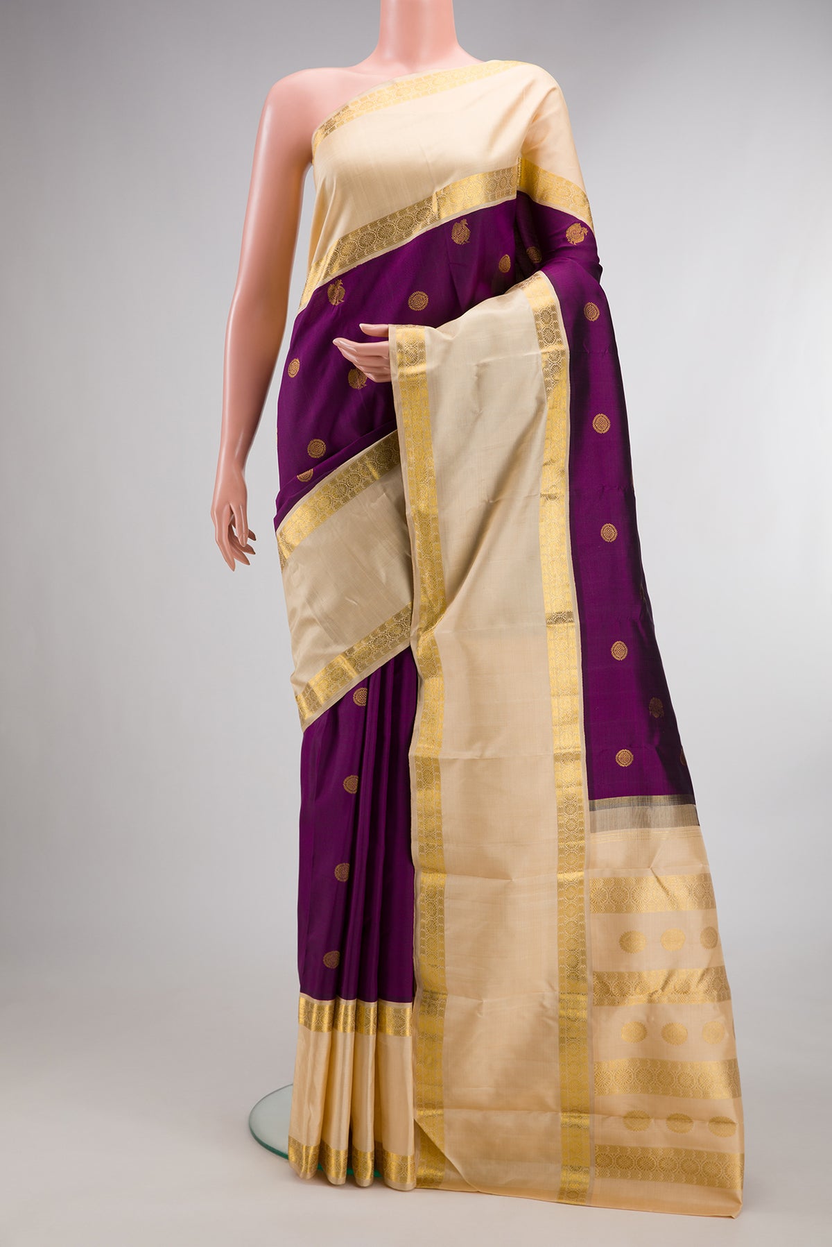 Pure Silk Purple Kanchipuram Saree with Zari Butta on the body and Zari Border.  displayed on a mannequin