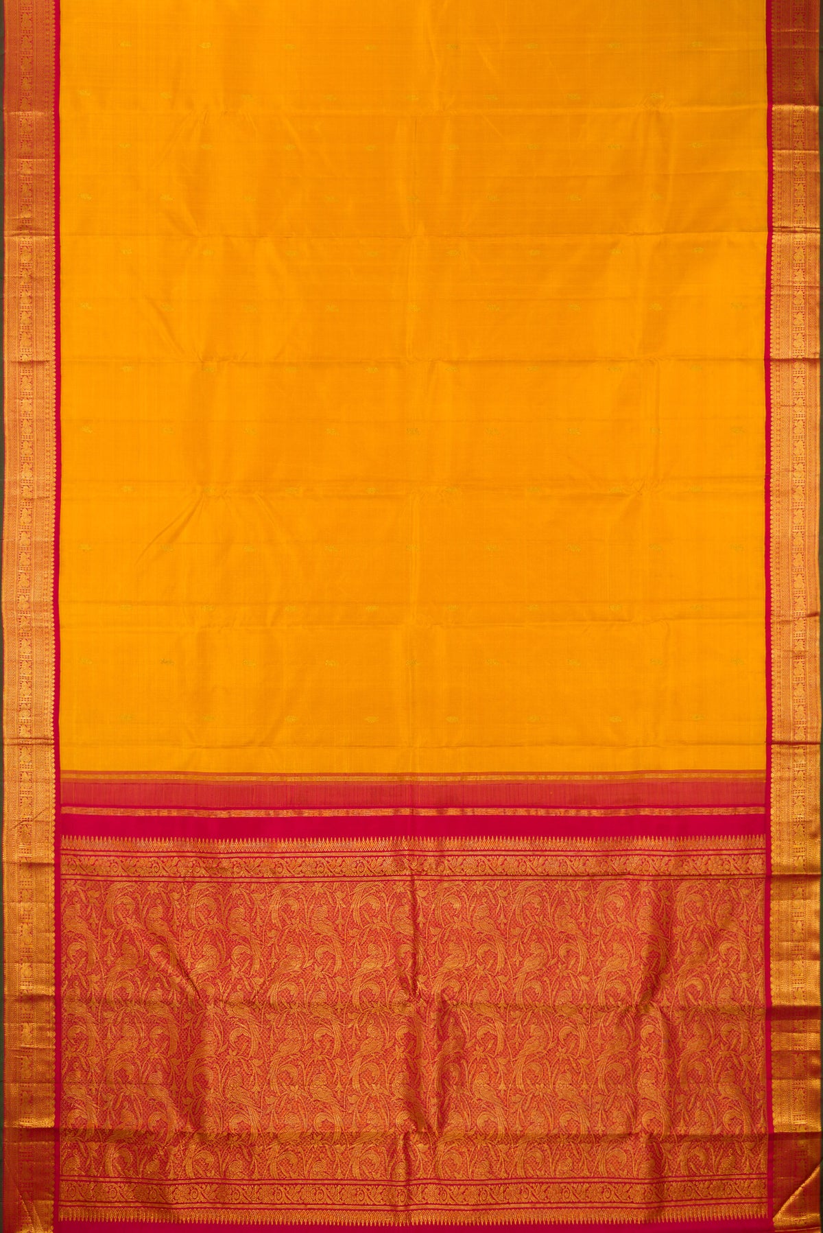 Flat view of Pure Silk Mustard Kanjivaram Saree with Zari Butta on the body and Zari Border. 