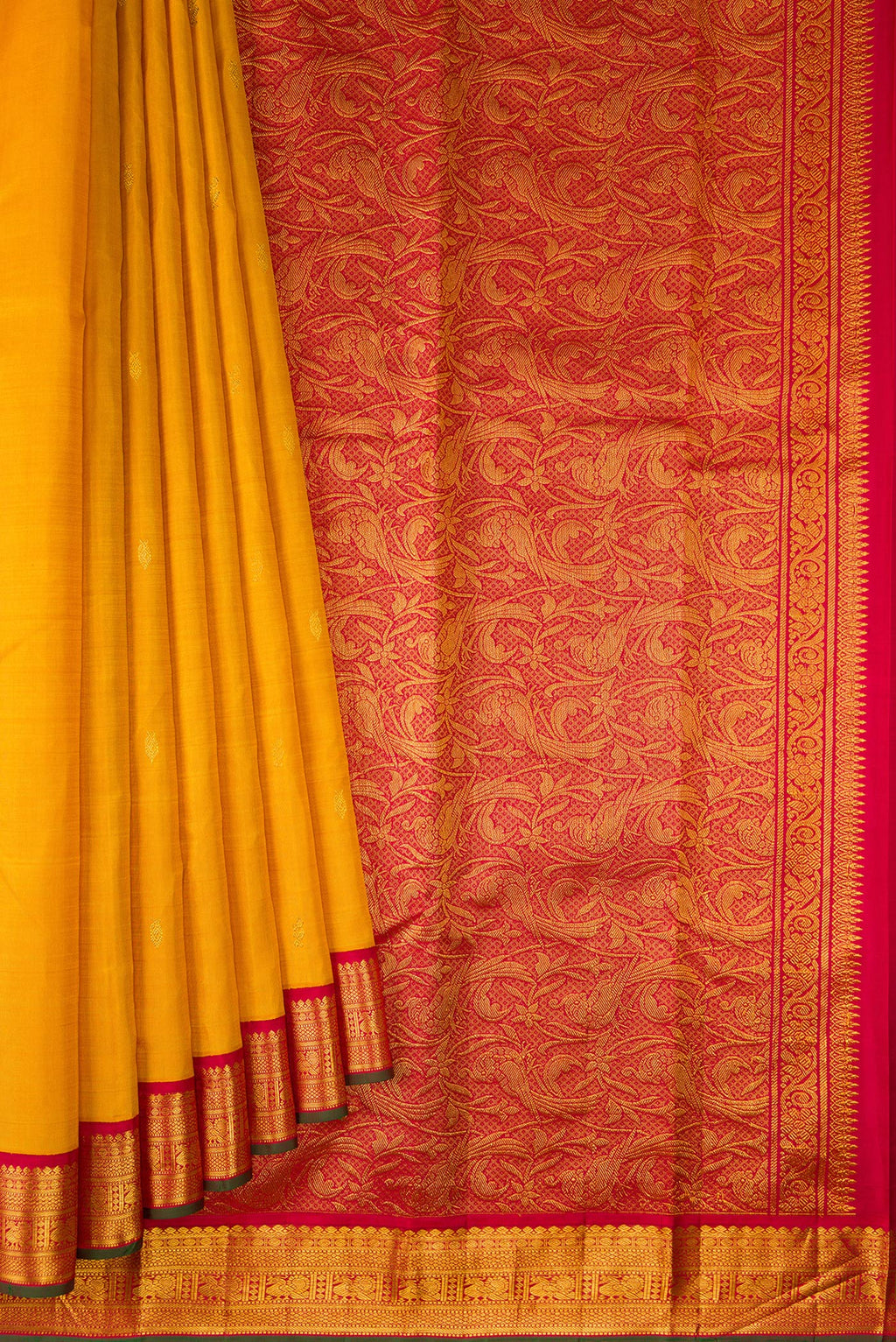 Pleats and pallu of Pure Silk Mustard Kanjivaram Saree with Zari Butta on the body and Zari Border. 