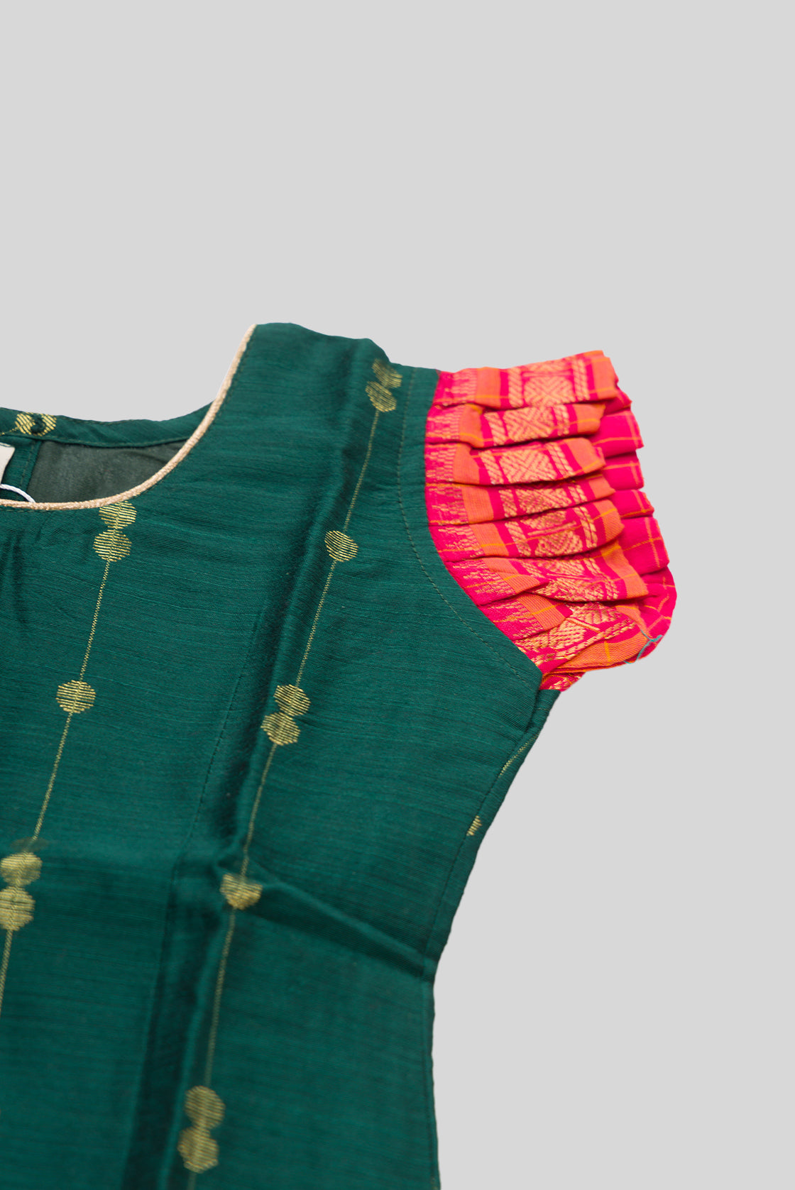 Close up sleeve details of Green Readymade Cotton Pavadai Set with Zari Butta on the body and Zari Border