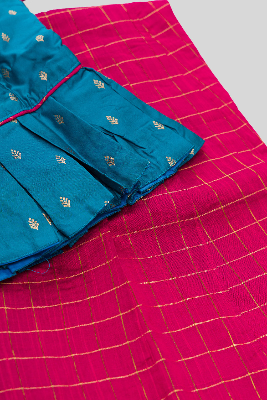 Detailed shot of Peacock Blue Readymade Cotton Pavadai Set with Zari Butta on the body and Zari Border