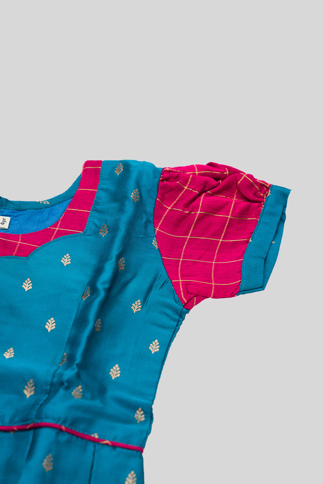 Close up sleeve details of Peacock Blue Readymade Cotton Pavadai Set with Zari Butta on the body and Zari Border