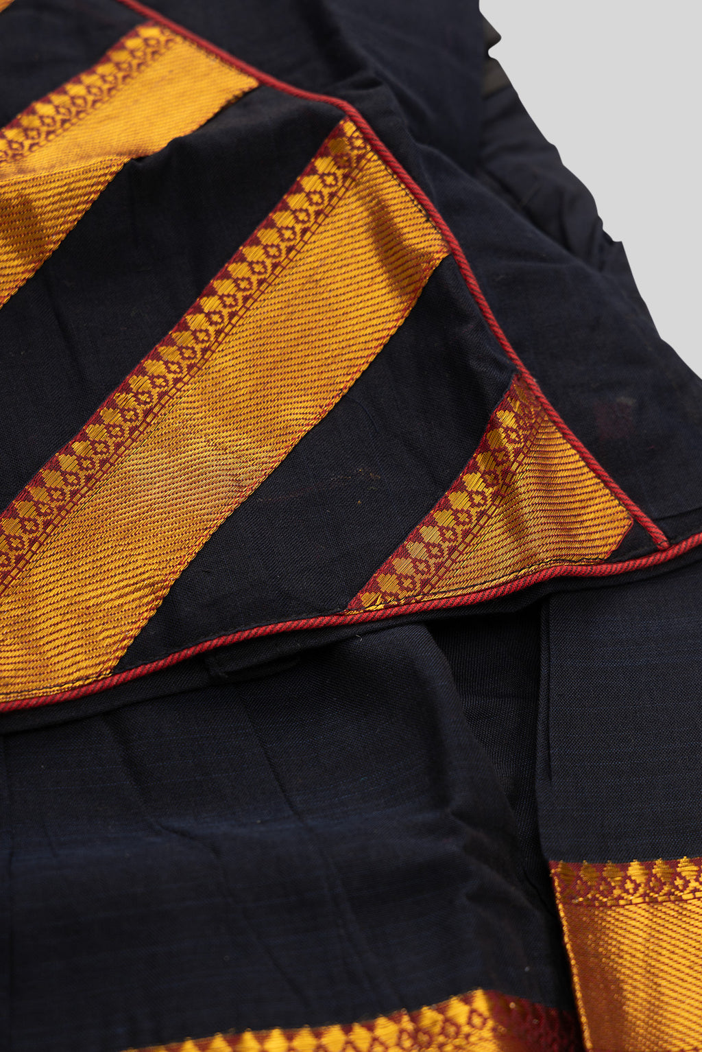 Detailed shot of Black Readymade Cotton Pavadai Set with Zari Butta on the body and Zari Border
