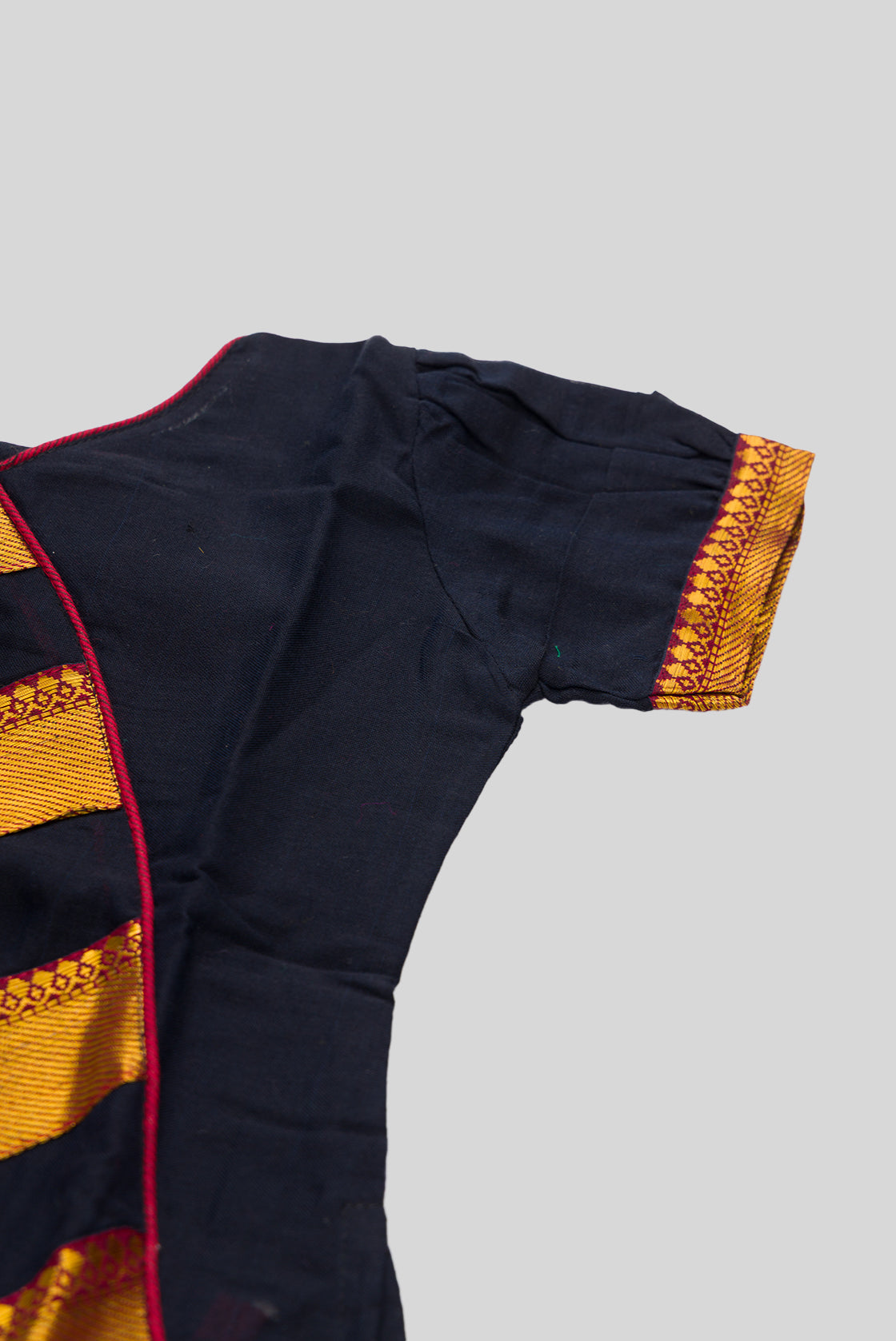 Close up sleeve details of Black Readymade Cotton Pavadai Set with Zari Butta on the body and Zari Border