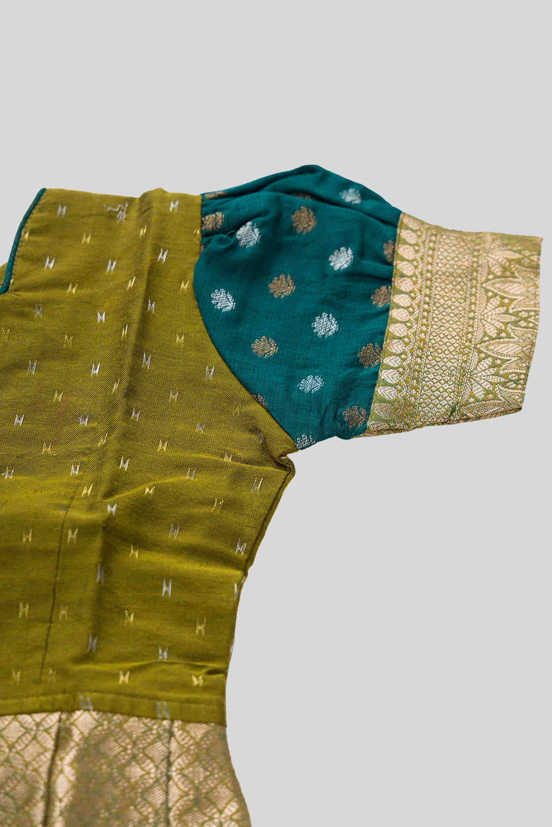 Close up sleeve details of Mehandi Green Readymade Cotton Pavadai Set with Zari Butta on the body and Zari Border