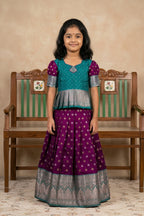 Green Readymade Cotton Pavadai Set with Zari Butta on the body and Zari Border displayed on a mannequin