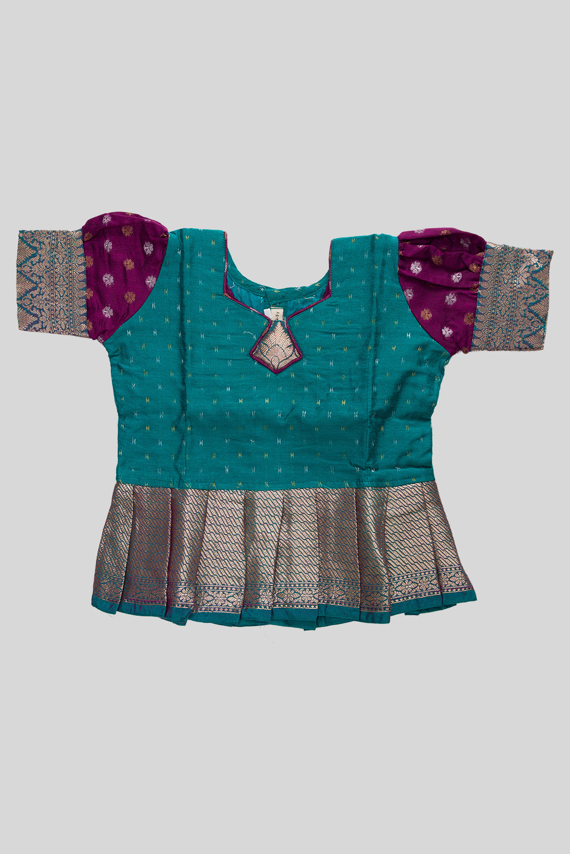 Close up blouse image of Green Readymade Cotton Pavadai Set with Zari Butta on the body and Zari Border