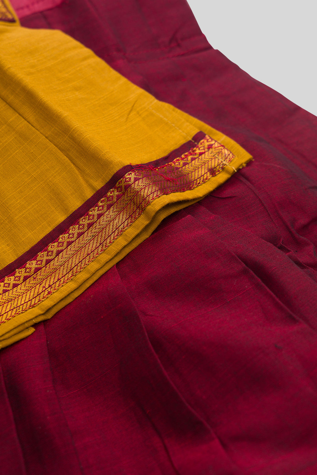 Detailed shot of Maroon Readymade Cotton Pavadai Set with  on the body and Zari Border