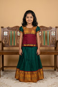 Green Readymade Cotton Pavadai Set with  on the body and Zari Border displayed on a mannequin