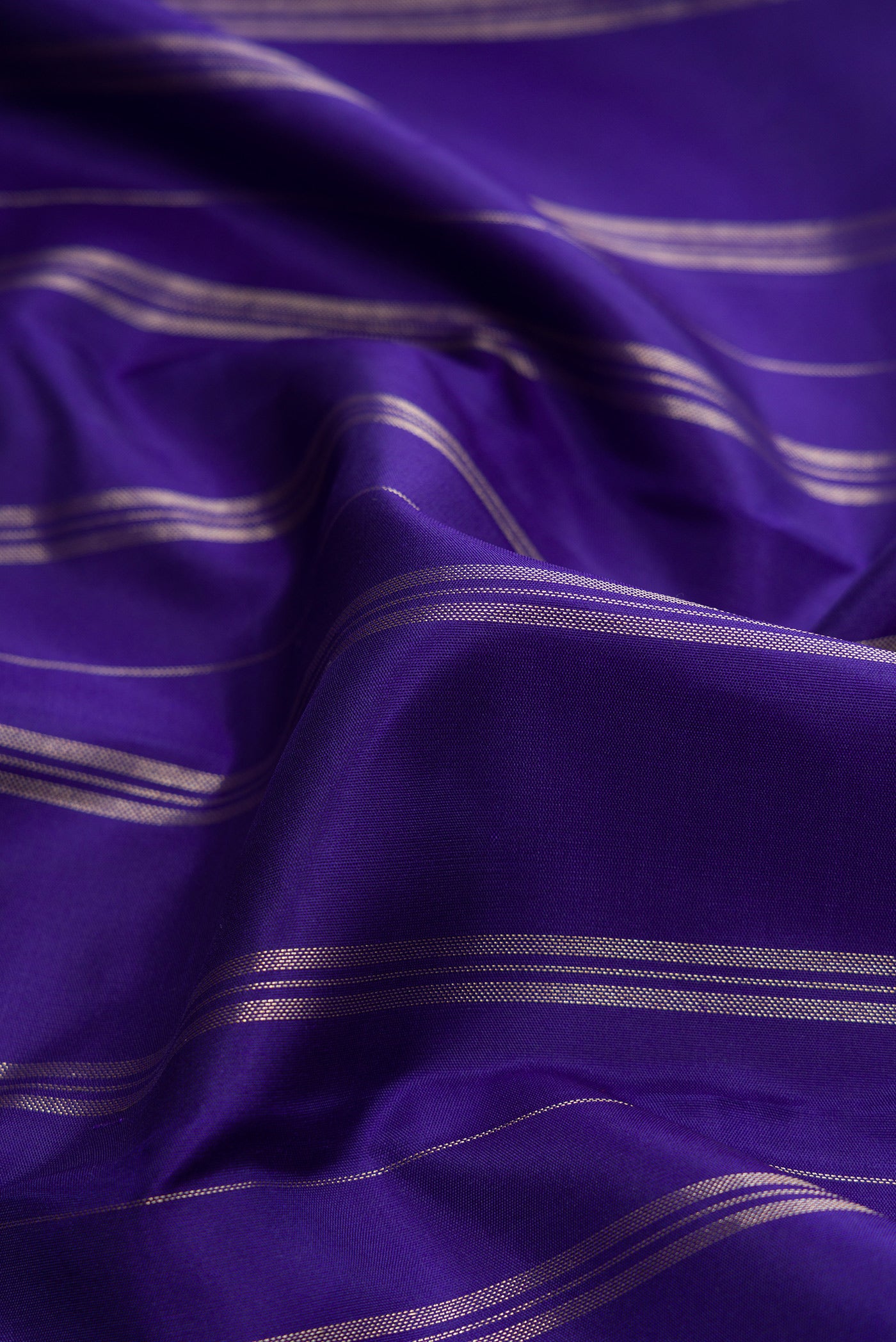 Close up of Royal Blue Dual Tone Kanjivaram Silk Saree with Stripes on the body and Fancy Border.  displaying folds