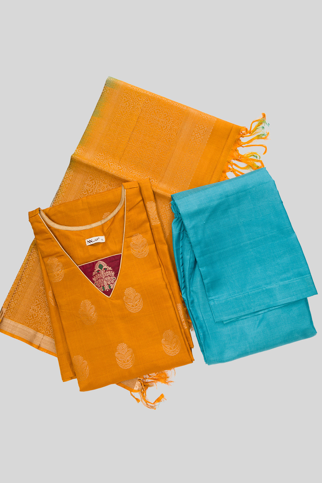 Flat lay of Mustard Pure Silk Womens Kurta set featuring Zari Butta Kurta paired with Light Blue Plain Body bottom and a Zari Butta dupatta in Light Blue