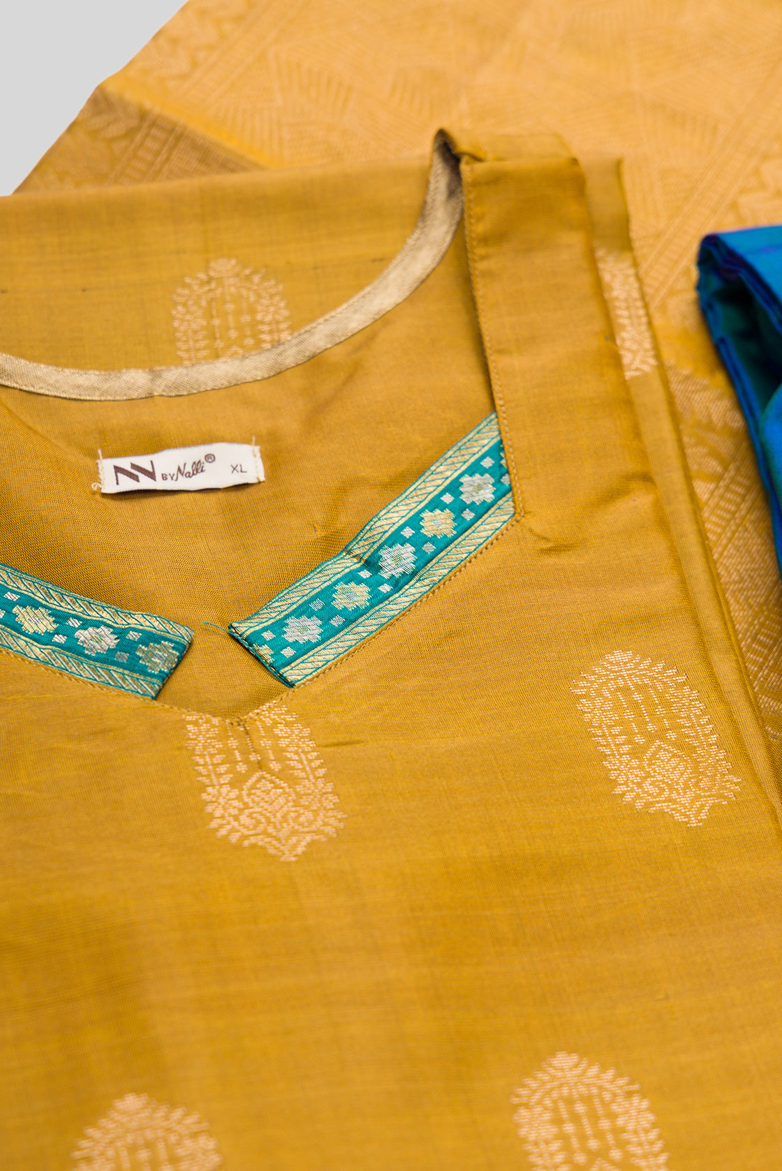 Detailed shot of Mehandi Green Pure Silk Womens Kurta set featuring Zari Butta Kurta paired with Peacock Blue Plain Body bottom and a Zari Butta dupatta in Peacock Blue