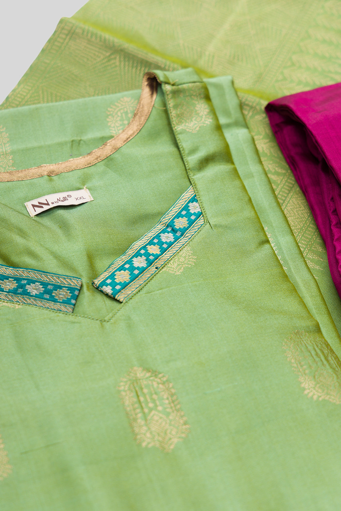 Detailed shot of Green Pure Silk Womens Kurta set featuring Zari Butta Kurta paired with Magenta Plain Body bottom and a Zari Butta dupatta in Magenta