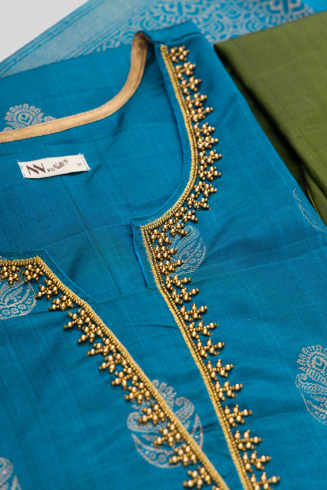 Detailed shot of Peacock Blue Pure Silk Womens Kurta set featuring Zari Butta Kurta paired with Green Plain Body bottom and a Zari Butta dupatta in Green