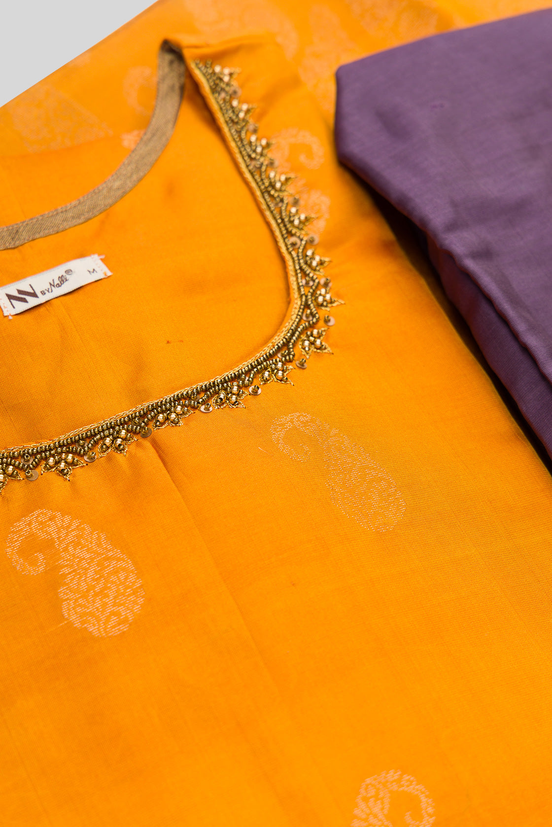 Detailed shot of Mustard Pure Silk Womens Kurta set featuring Zari Butta Kurta paired with Lavender Plain Body bottom and a Zari Butta dupatta in Lavender