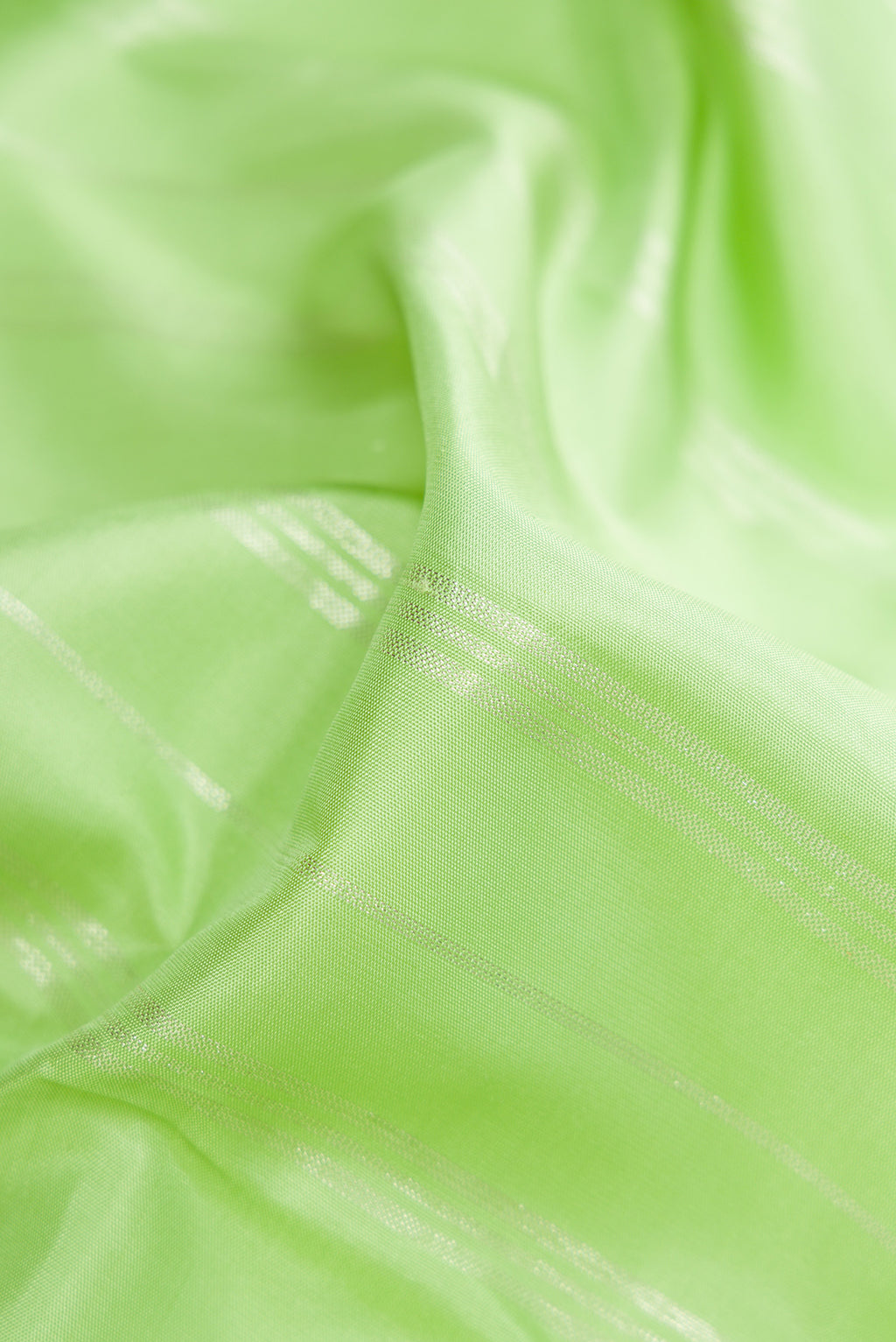 Close up of Pista Green Kanjivaram Silk Saree with Stripes on the body and Without Border.  displaying folds