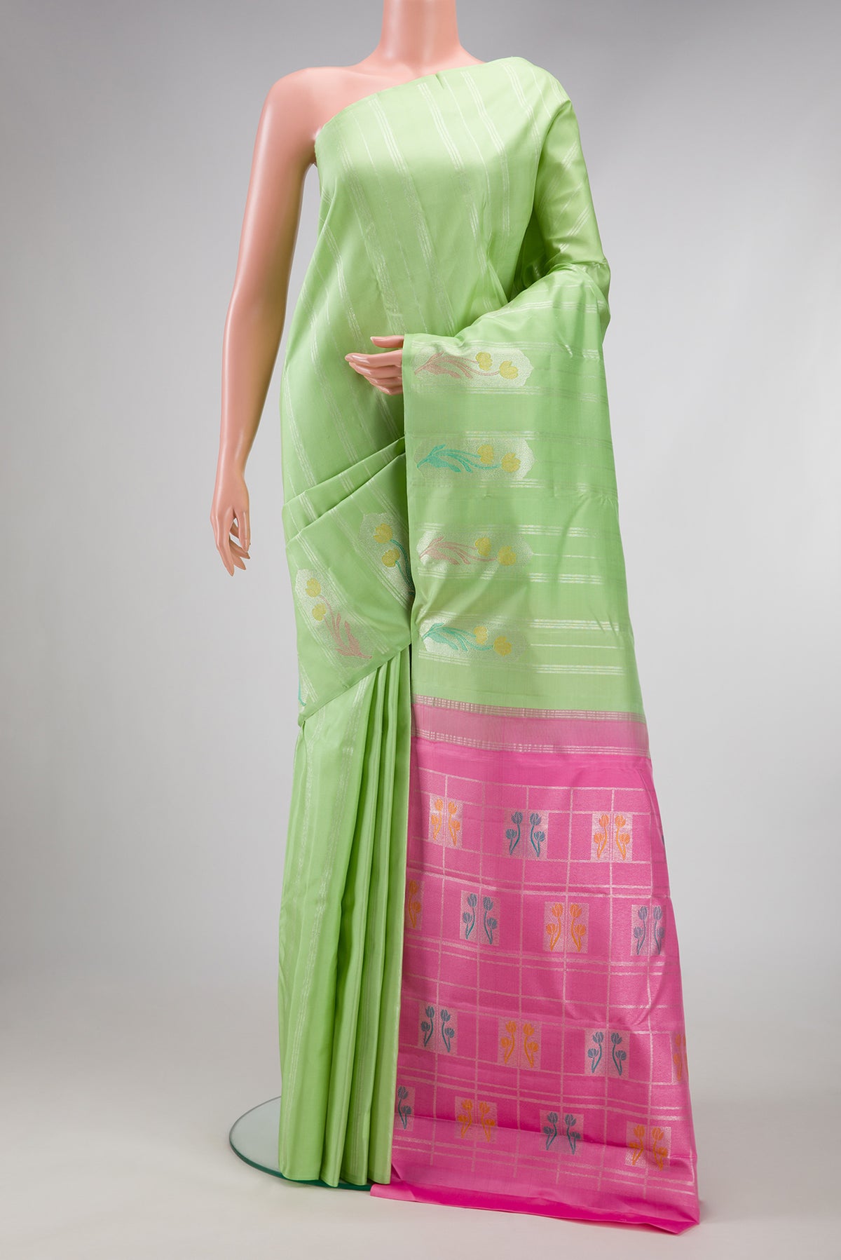 Pista Green Kanjivaram Silk Saree with Stripes on the body and Without Border.  displayed on a mannequin