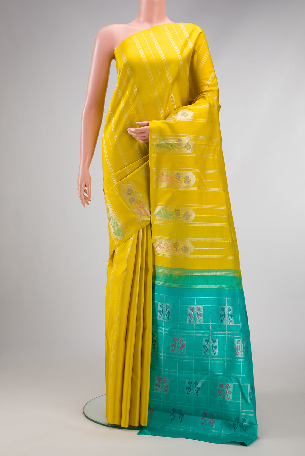 Yellow Kanjivaram Silk Saree with Stripes on the body and Without Border.  displayed on a mannequin