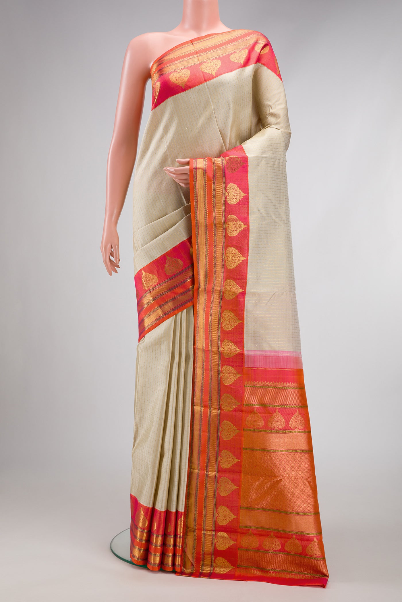 Beige Dual Tone Kanchipuram Silk Saree with Stripes on the body and Fancy Border.  displayed on a mannequin