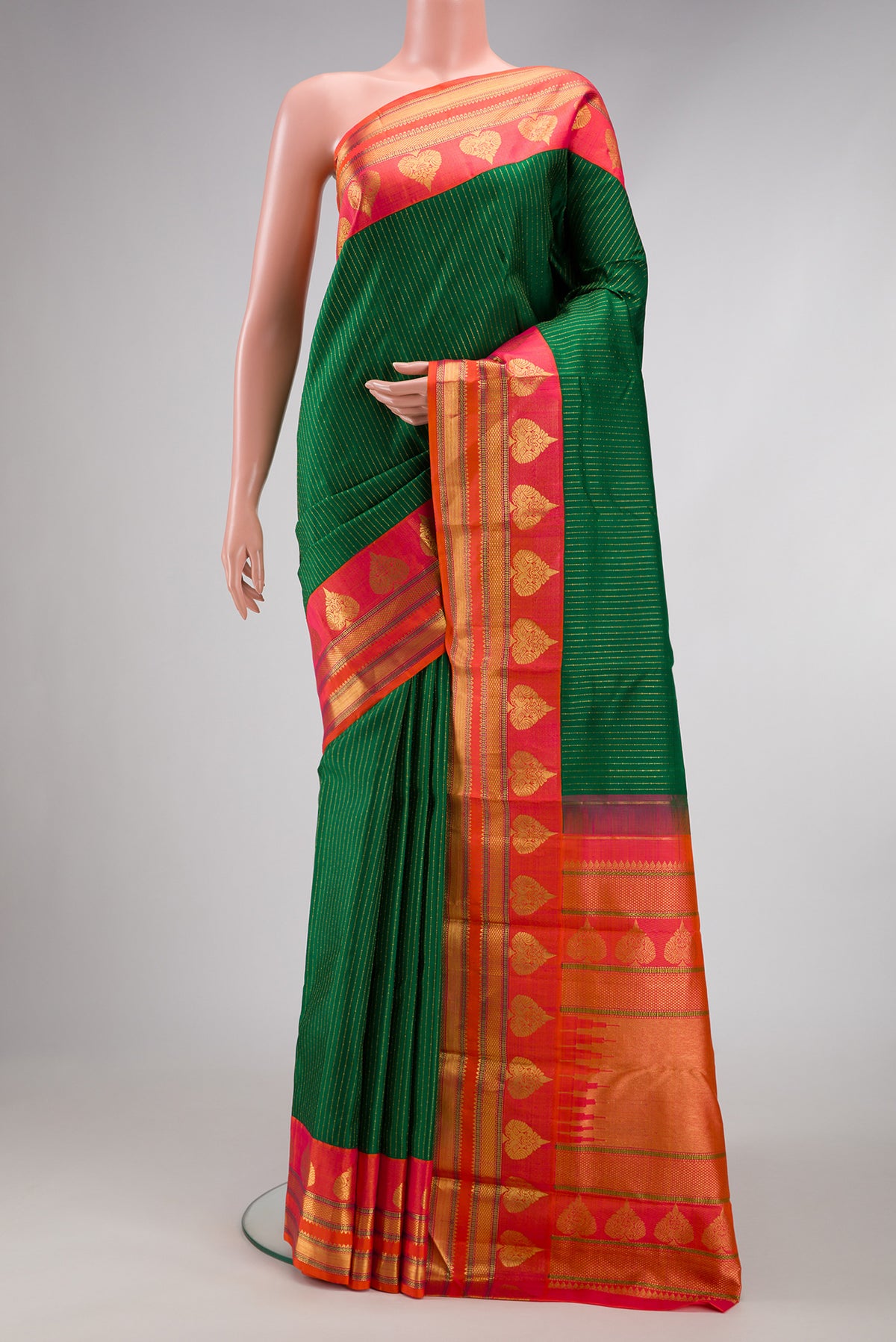 Bottle Green Kanchipuram Silk Saree with Stripes on the body and Zari Border.  displayed on a mannequin