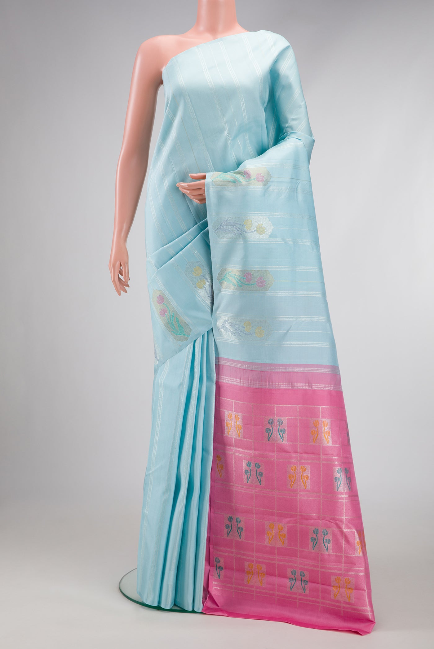 Light Blue Kanjivaram Silk Saree with Stripes on the body and Without Border.  displayed on a mannequin