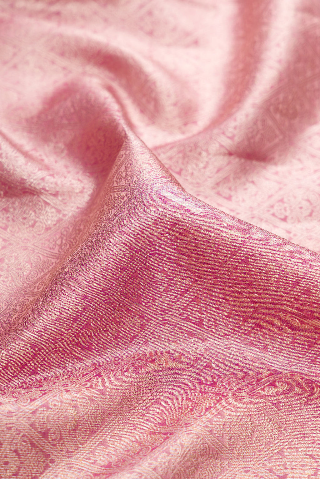 Close up of Rose Gold Kanchipuram Silk Saree with Zari Brocade on the body and Zari Border.  displaying folds