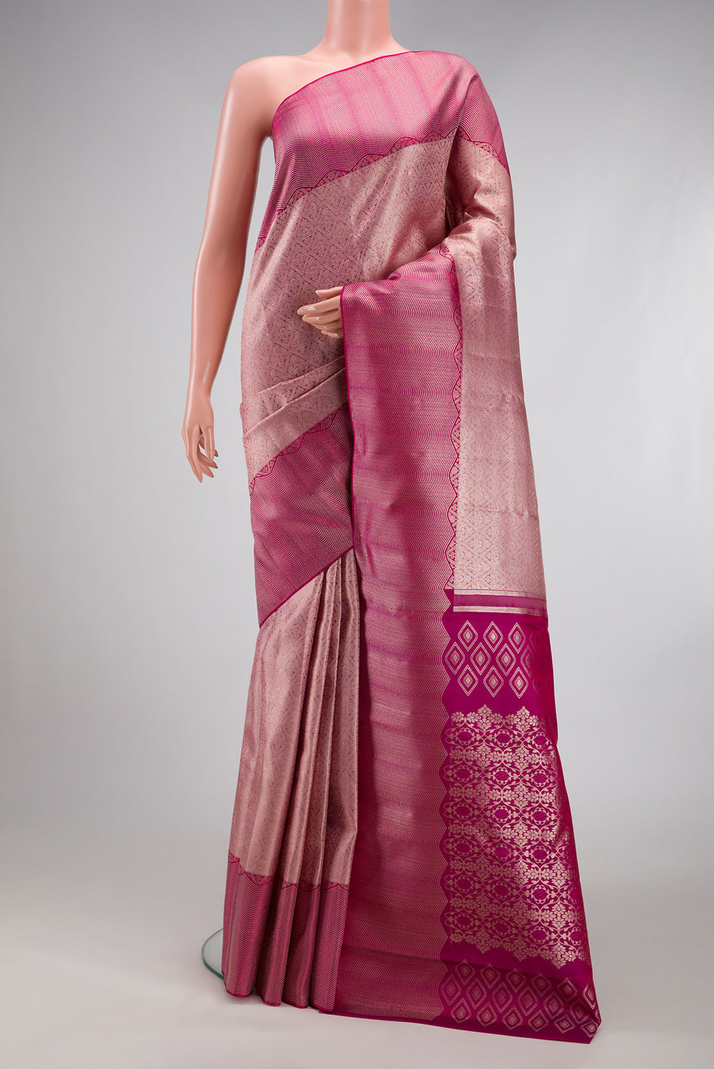 Rose Gold Kanchipuram Silk Saree with Zari Brocade on the body and Zari Border.  displayed on a mannequin