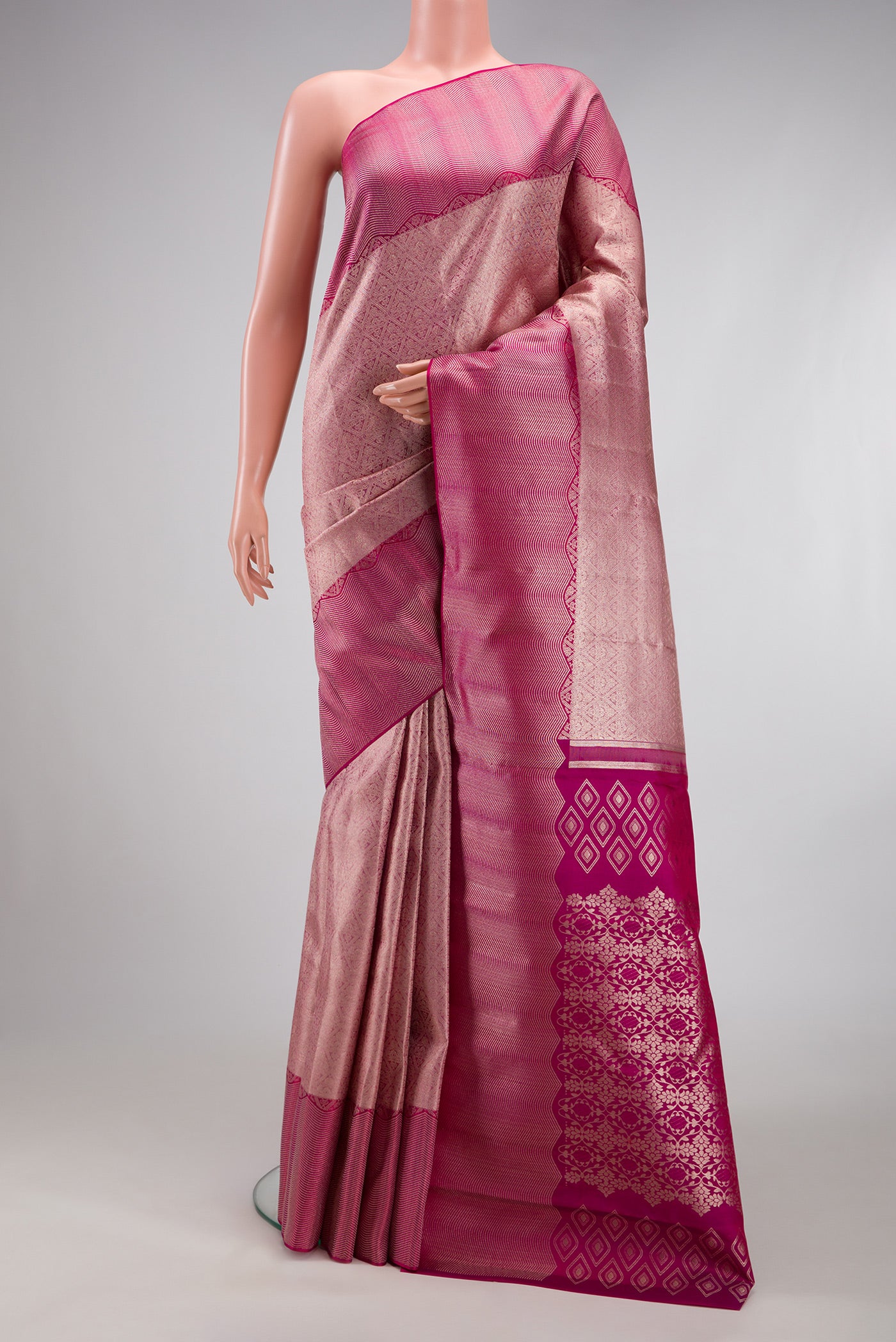 Rose Gold Kanchipuram Silk Saree with Zari Brocade on the body and Zari Border.  displayed on a mannequin