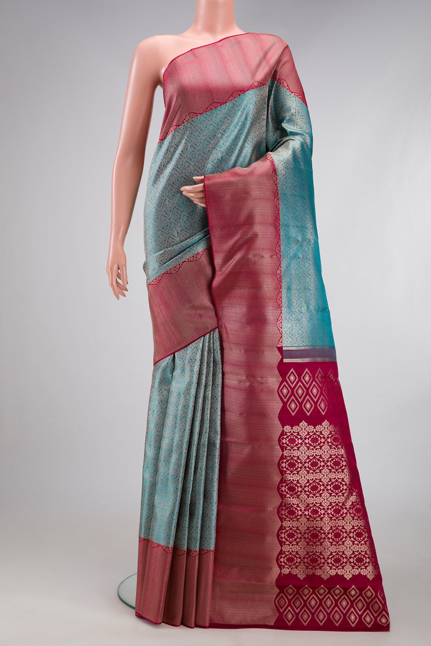 Light Blue Kanchipuram Silk Saree with Zari Brocade on the body and Zari Border.  displayed on a mannequin