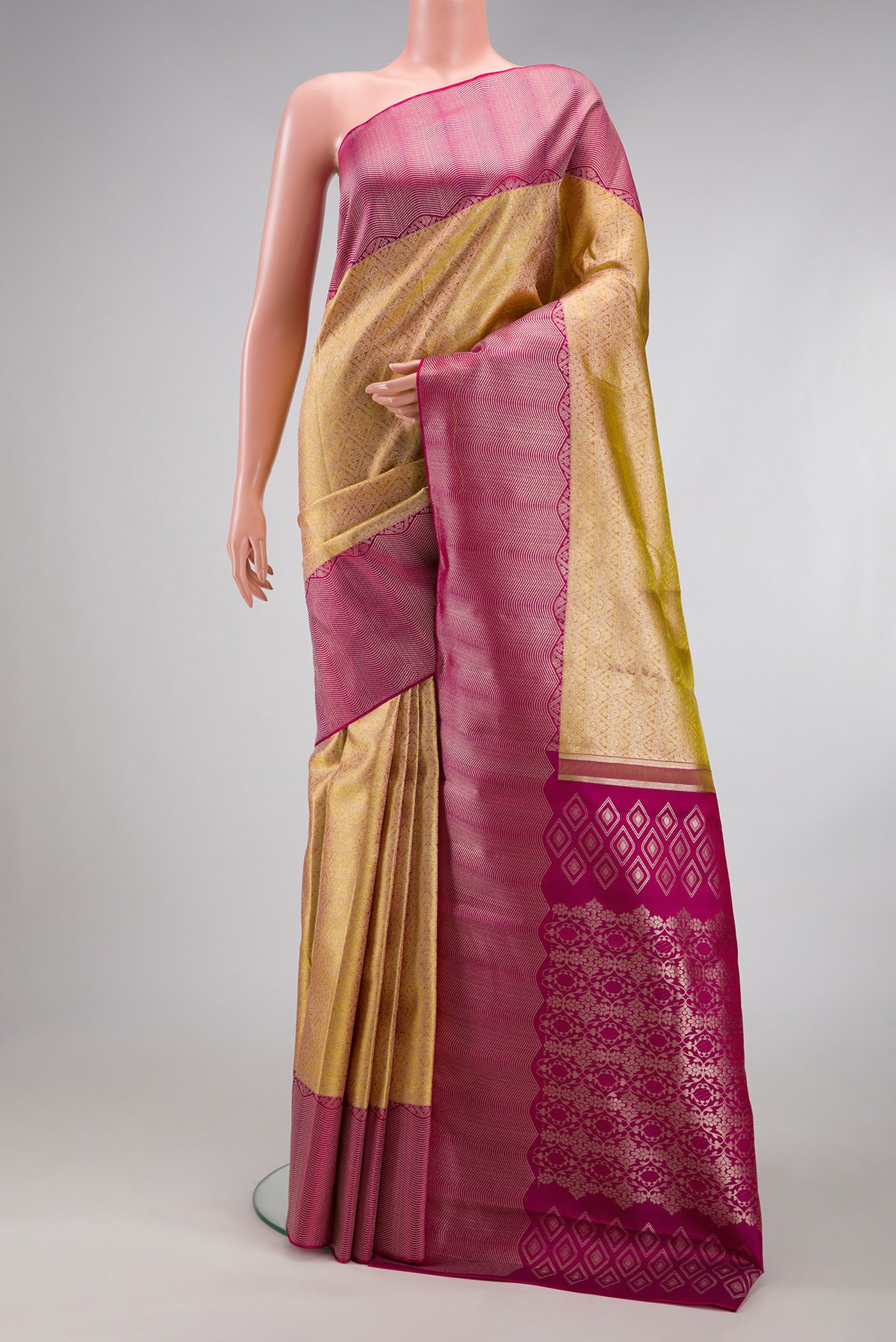 Gold Kanchipuram Silk Saree with Zari Brocade on the body and Zari Border.  displayed on a mannequin