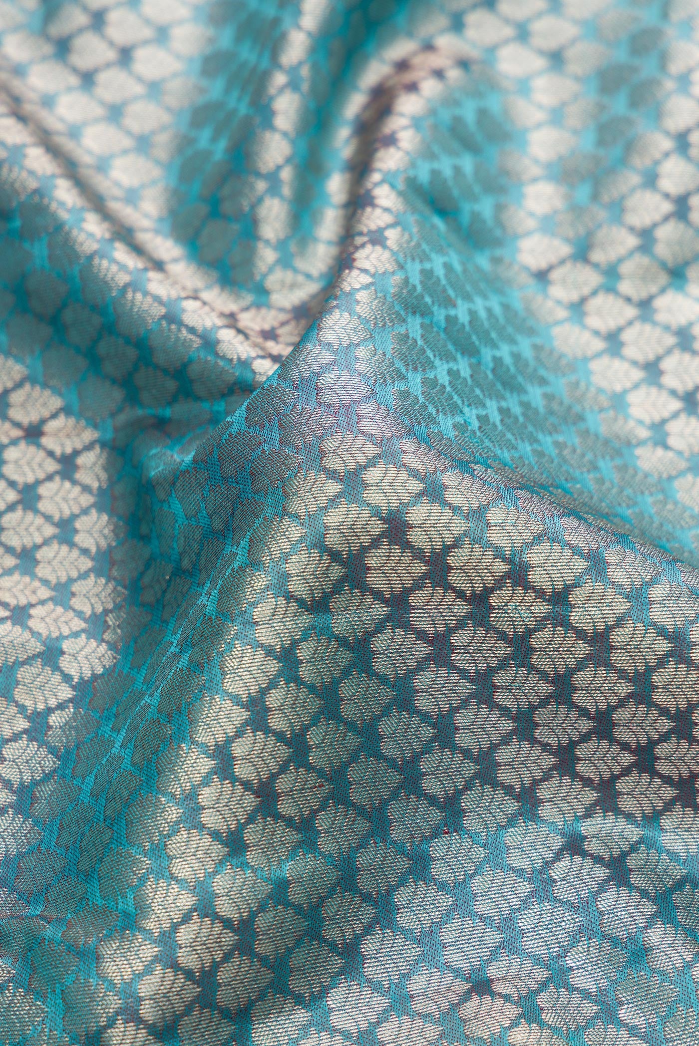 Close up of Sky Blue Kanchipuram Silk Saree with Zari Brocade on the body and Fancy Border.  displaying folds