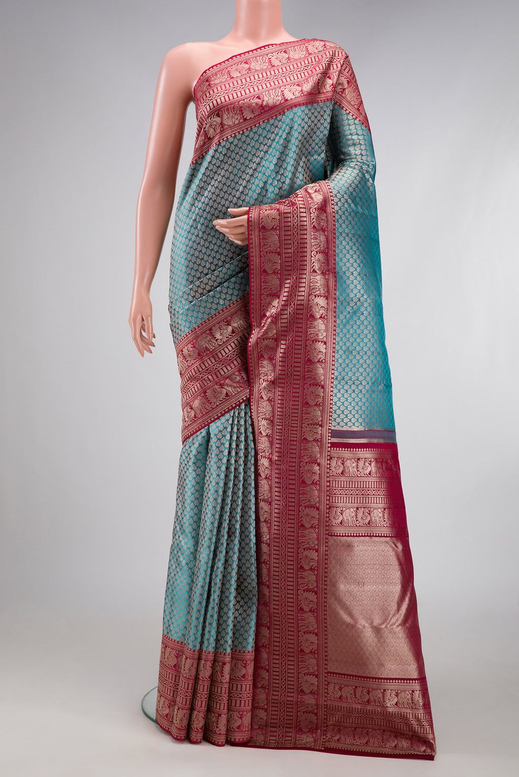 Sky Blue Kanchipuram Silk Saree with Zari Brocade on the body and Fancy Border.  displayed on a mannequin