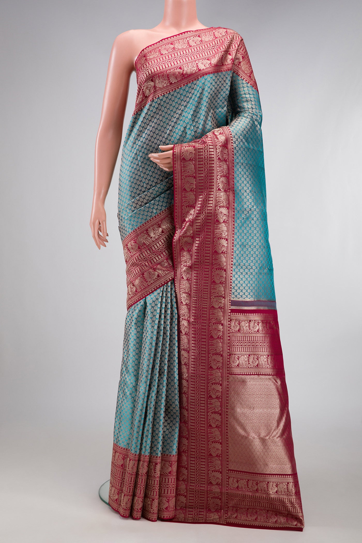 Sky Blue Kanchipuram Silk Saree with Zari Brocade on the body and Fancy Border.  displayed on a mannequin