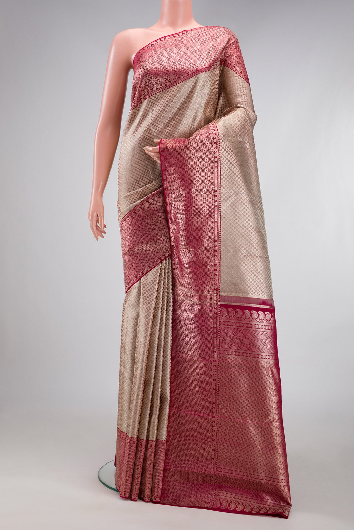 Grey Kanchipuram Silk Saree with Zari Brocade on the body and Zari Border.  displayed on a mannequin