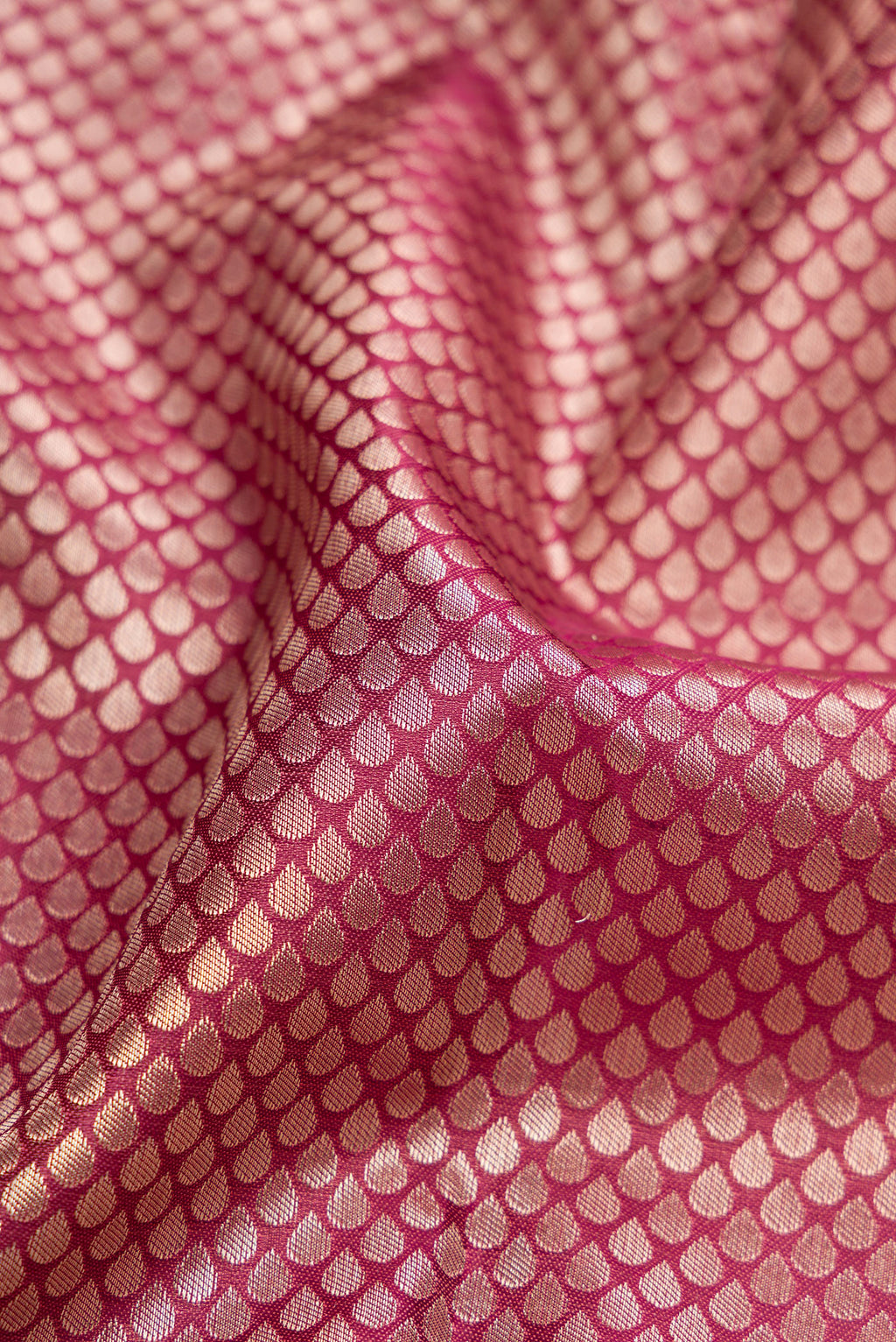 Close up of Maroon Dual Tone Kanchipuram Tissue Silk Saree with Zari Brocade on the body and Fancy Border.  displaying folds