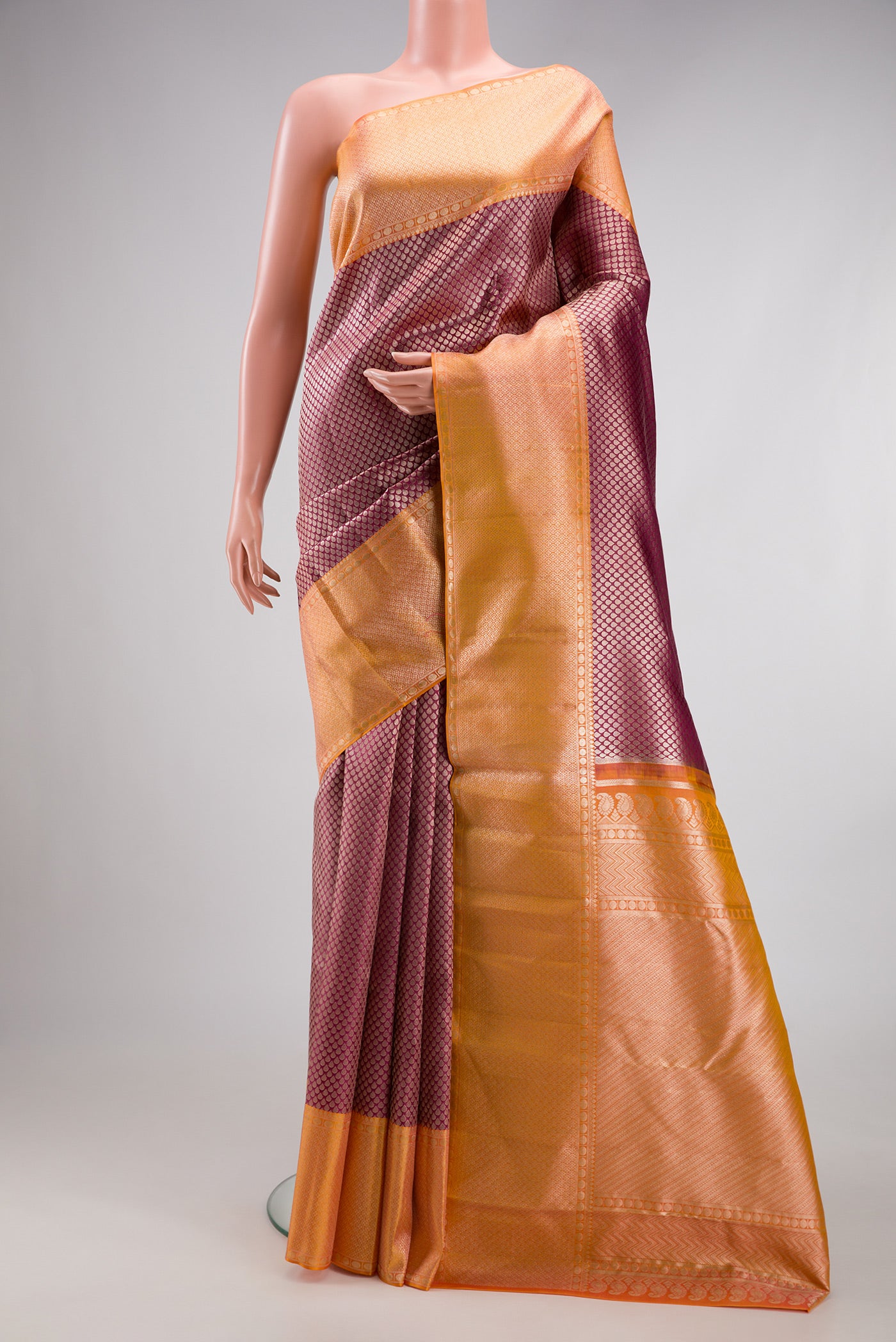 Maroon Dual Tone Kanchipuram Tissue Silk Saree with Zari Brocade on the body and Fancy Border.  displayed on a mannequin