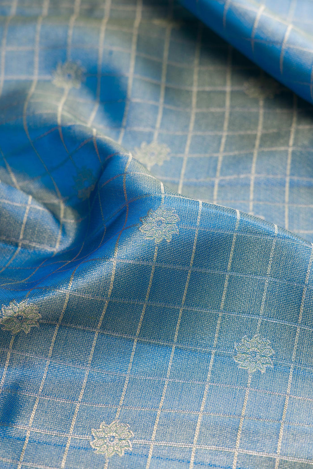 Close up of Light Blue Kanchipuram Tissue Silk Saree with Zari Brocade on the body and Fancy Border.  displaying folds