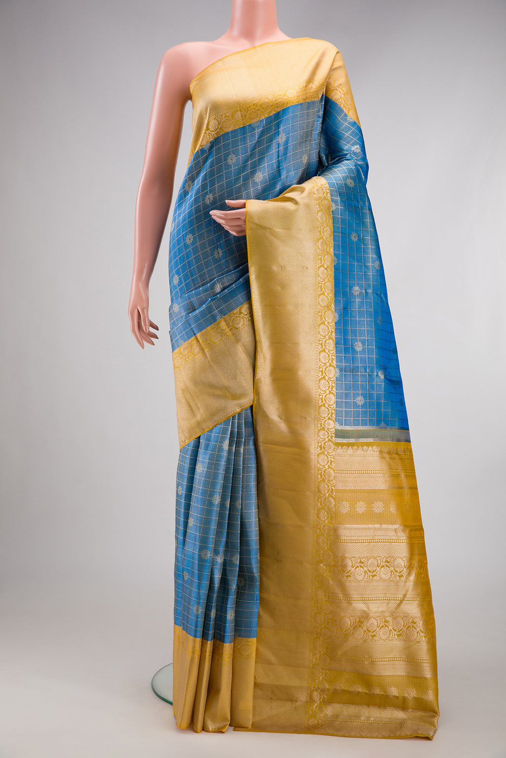 Light Blue Kanchipuram Tissue Silk Saree with Zari Brocade on the body and Fancy Border.  displayed on a mannequin