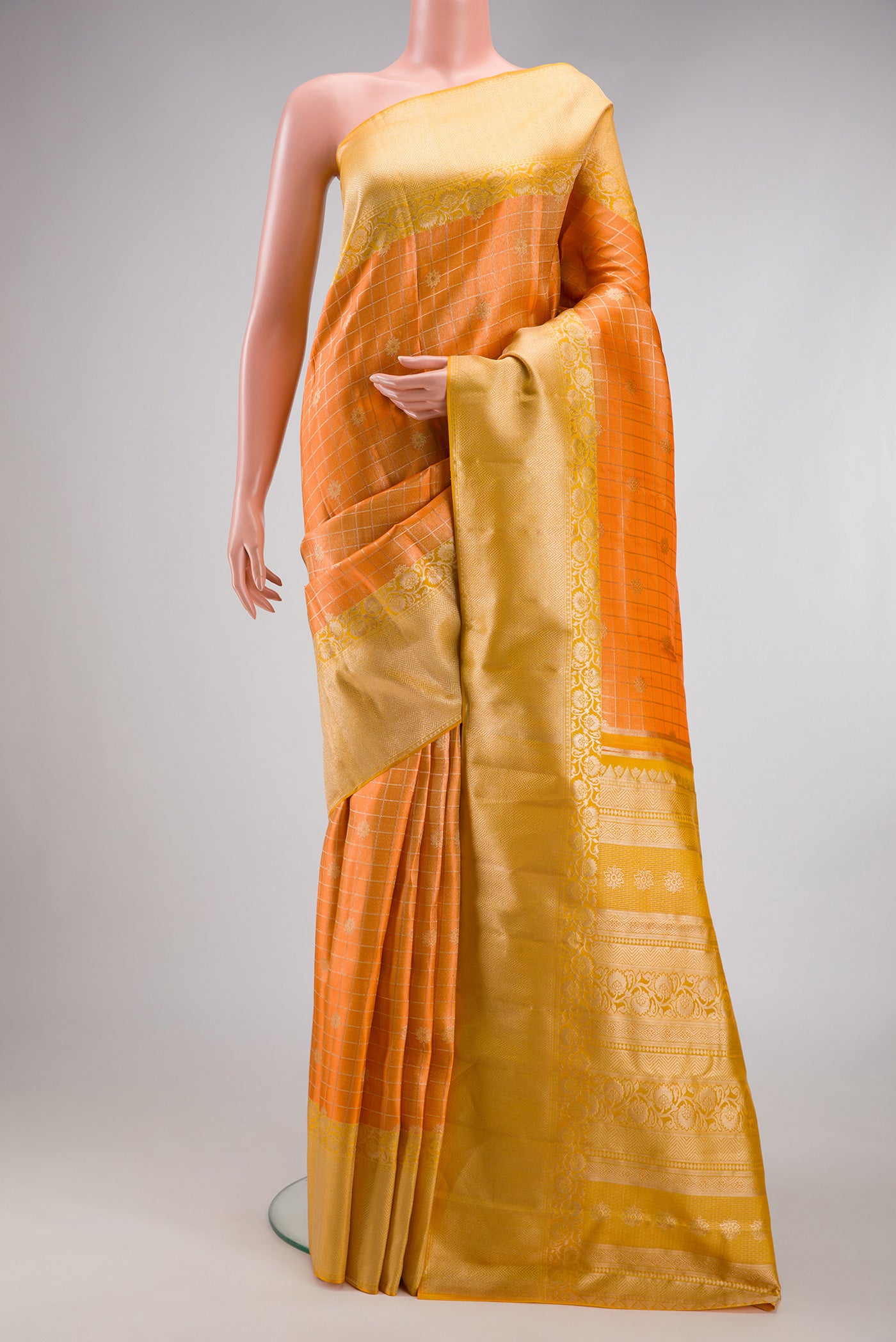 Orange Dual Tone Kanchipuram Tissue Silk Saree with Zari Brocade on the body and Fancy Border.  displayed on a mannequin