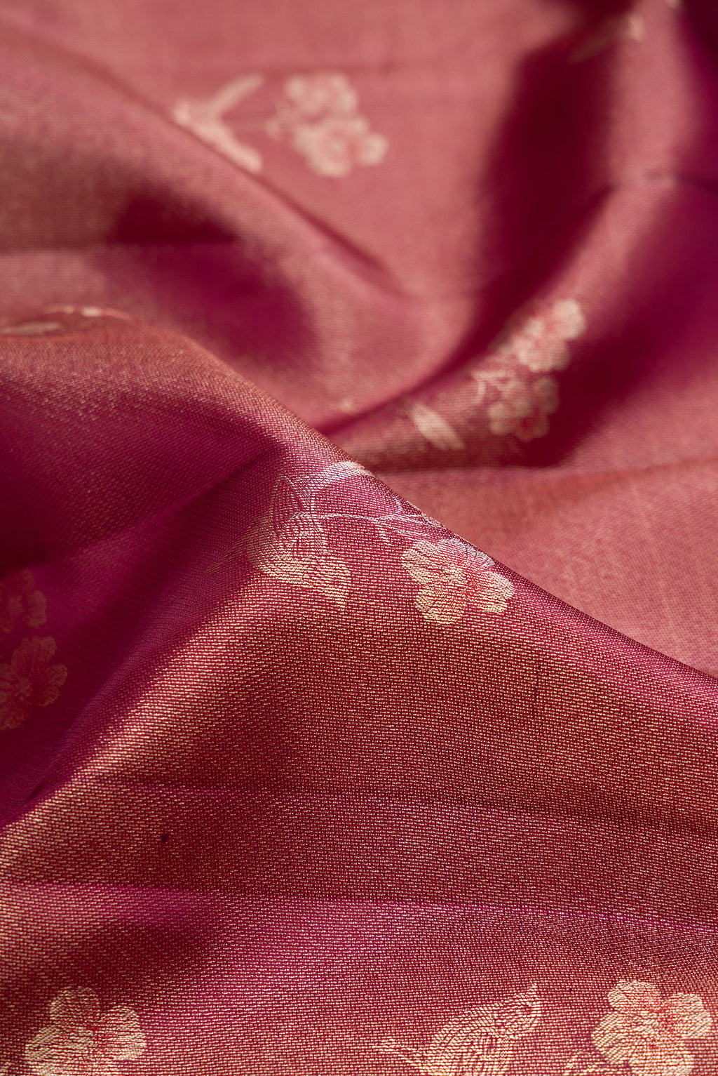 Close up of Maroon Dual Tone Kanchipuram Tissue Silk Saree with Zari Brocade on the body and Fancy Border.  displaying folds