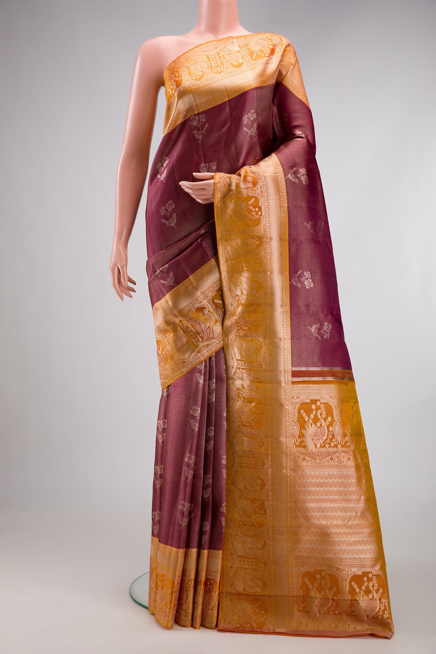 Maroon Dual Tone Kanchipuram Tissue Silk Saree with Zari Brocade on the body and Fancy Border.  displayed on a mannequin