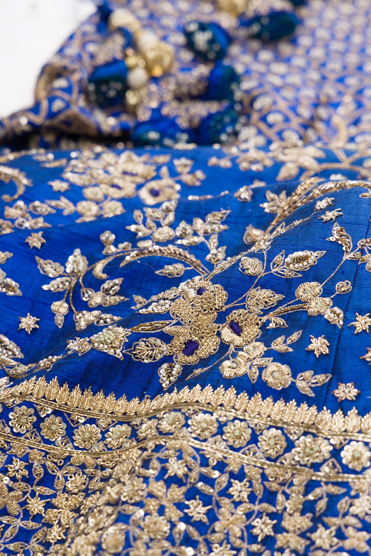 Royal Blue Raw Silk Womens Lehenga set featuring Embroidered Choli paired with Royal Blue Embroidered Skirt with Embroidered Border and a Embroidered dupatta in Light Green.