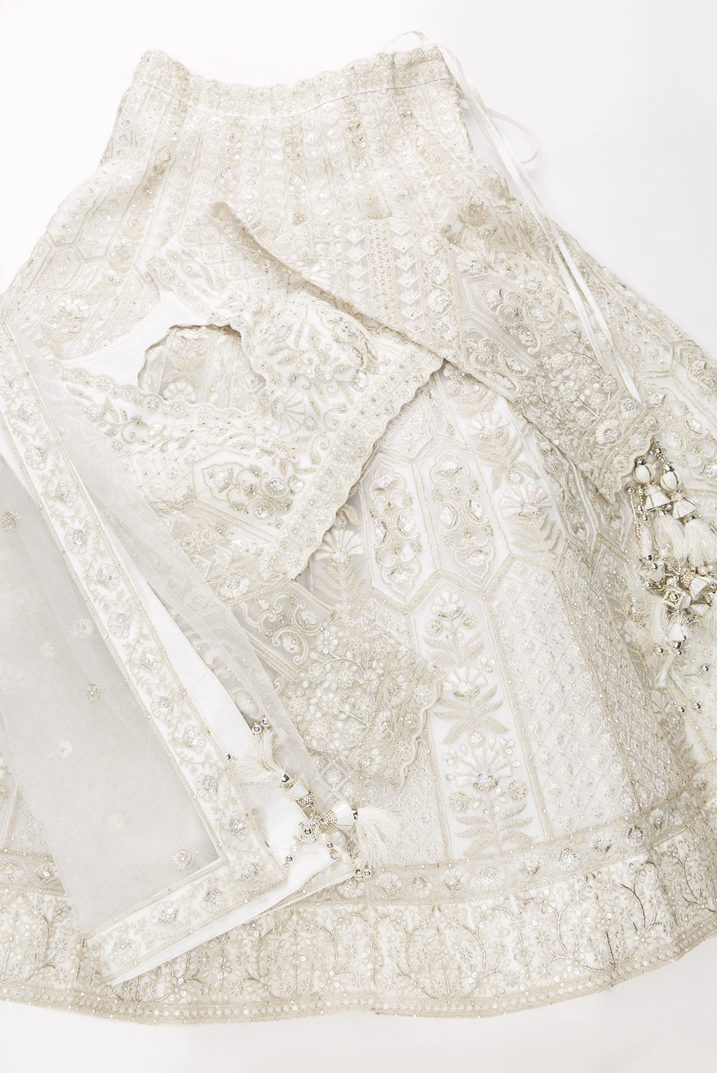 Flat lay of Off White Banarasi Silk Womens Lehenga set featuring Embroidered Choli paired with Off White Embroidered Skirt with Embroidered Border and a Embroidered dupatta in Off White