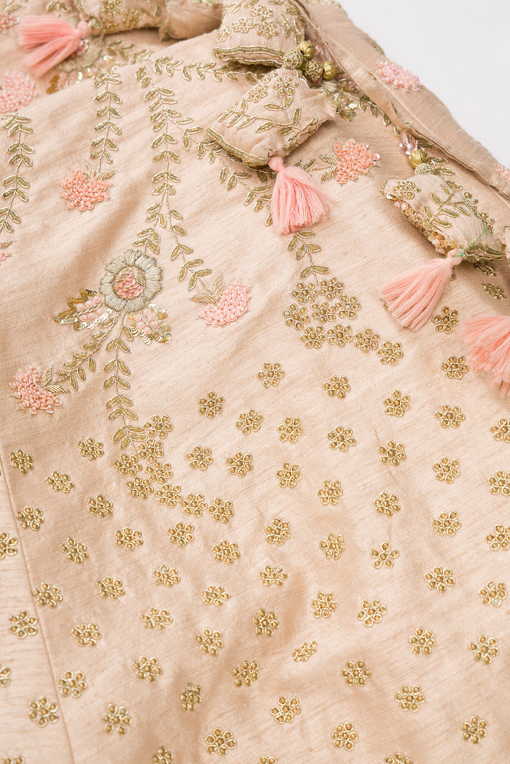 Detailed shot of Rose Gold Banarasi Silk Womens Lehenga set featuring Embroidered Choli paired with Rose Gold Embroidered Skirt with Embroidered Border and a Embroidered dupatta in Rose Gold