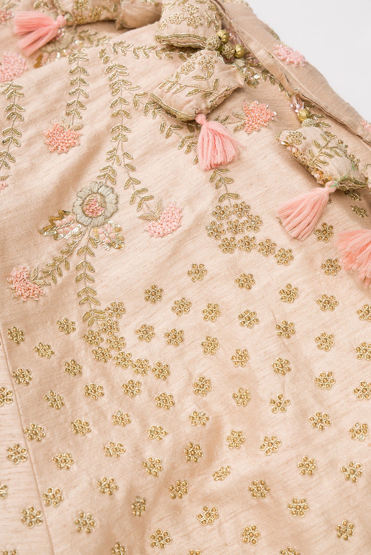 Detailed shot of Rose Gold Banarasi Silk Womens Lehenga set featuring Embroidered Choli paired with Rose Gold Embroidered Skirt with Embroidered Border and a Embroidered dupatta in Rose Gold
