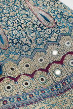 Detailed shot of Peacock Blue Banarasi Silk Womens Lehenga set featuring Embroidered Choli paired with Peacock Blue Embroidered Skirt with Embroidered Border and a Embroidered dupatta in Pink