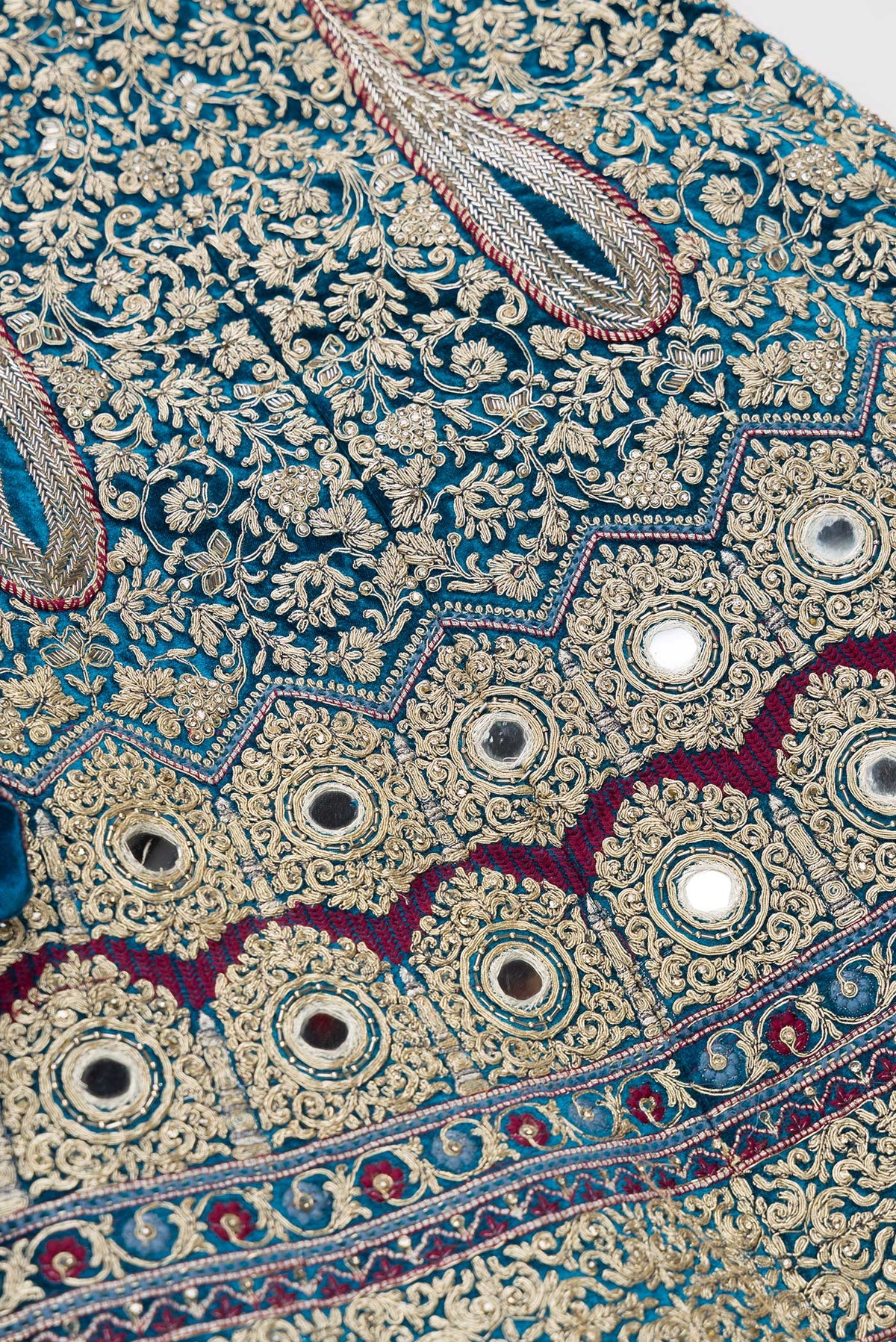 Detailed shot of Peacock Blue Banarasi Silk Womens Lehenga set featuring Embroidered Choli paired with Peacock Blue Embroidered Skirt with Embroidered Border and a Embroidered dupatta in Pink